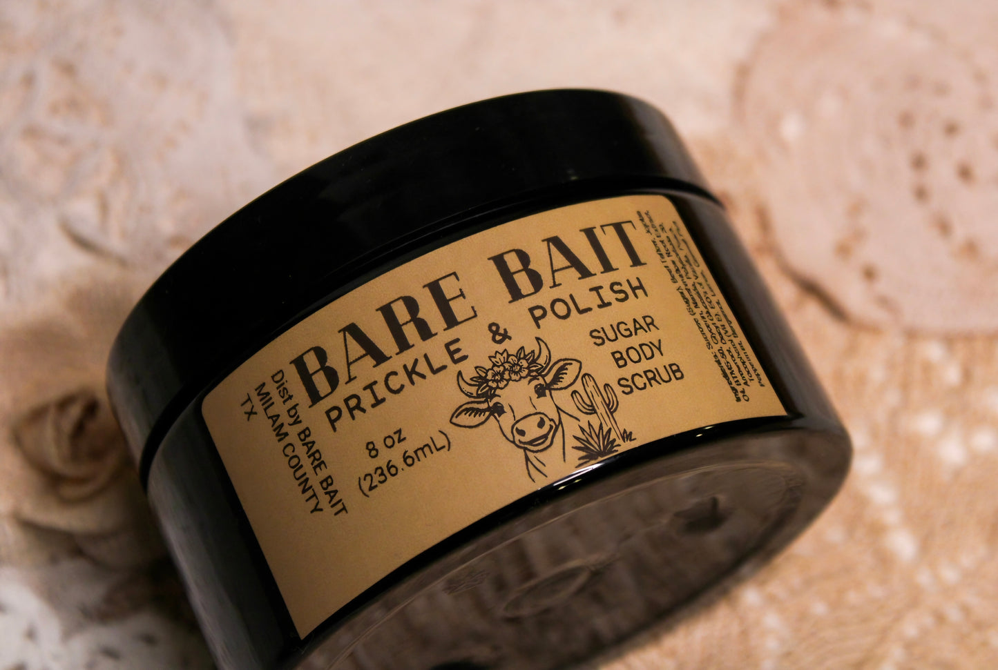 Jar of Bare Bait Prickle & Polish Sugar Body Scrub on a textured beige background